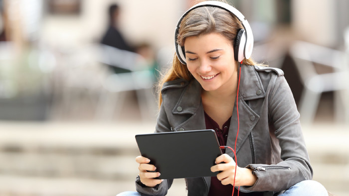 © Antonio Guillem, stock.adobe.com Frau sieht auf Tablet und benützt ein HeadSet © Antonio Guillem, stock.adobe.com