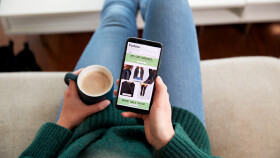 Nahaufnahme einer Frau, die mit der Handy-App online Kleidung kauft