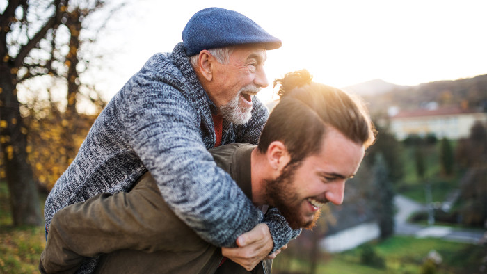 Älterer Vater und sein Sohn wandern in der Natur, haben Spaß